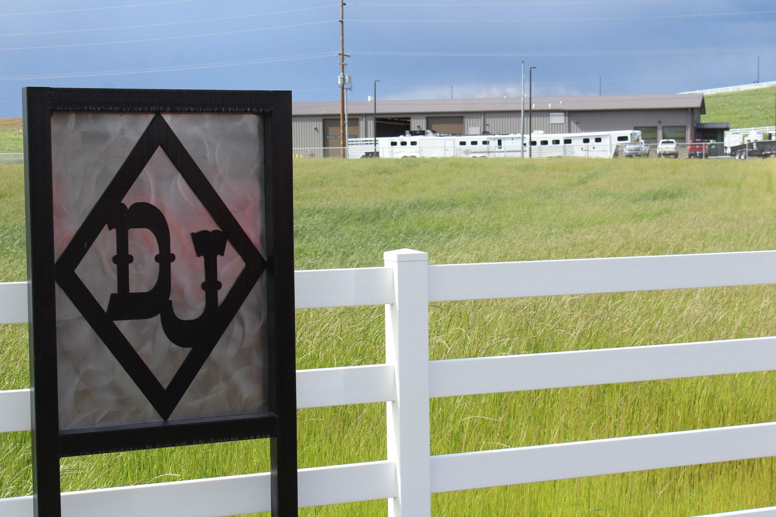 The Don Johnson Sales diamond logo sign on the white fence at the Walla Walla lot