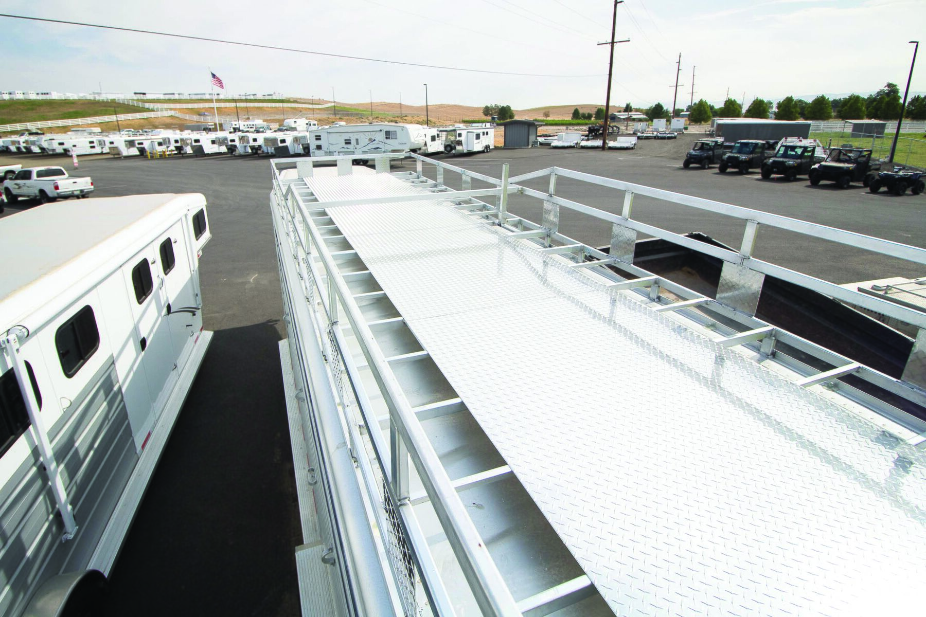 Diamond plate walkway and safety rail on a finished custom aluminum deck rack