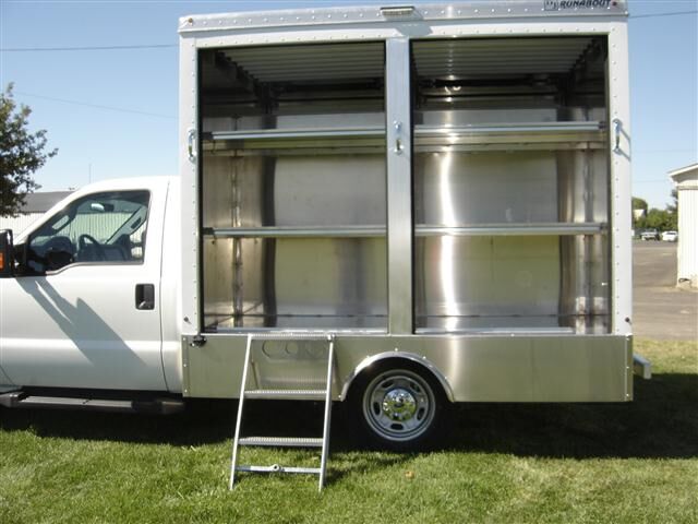 Fabricated aluminum shelving and fold-down step inside a custom delivery body
